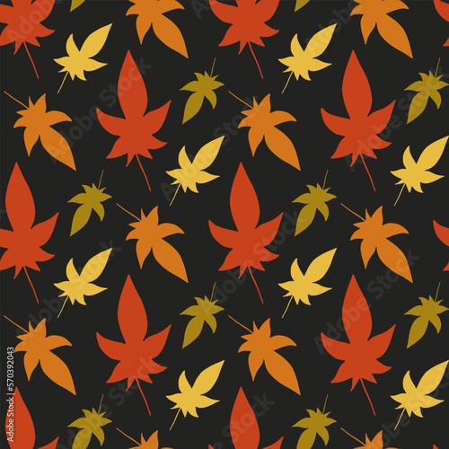 Seamless pattern with autumn leaves on a black background. Vector image.