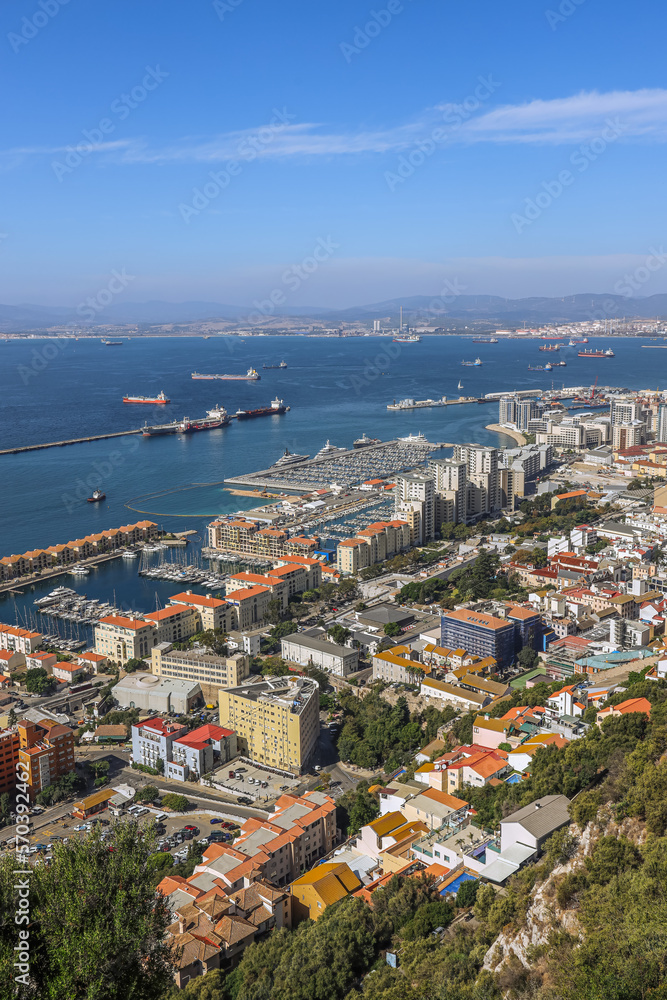 Scenic view of Gibraltar city and bay on southern part of Iberian Peninsula, Spain on the horizon. View from top of hill. 