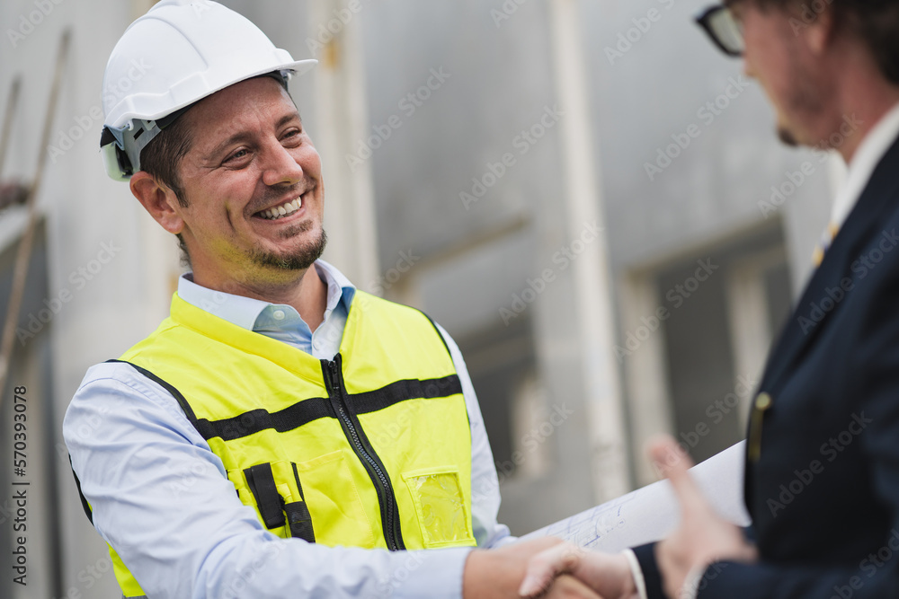 Happy caucasian engineer man check hand with manager in precast site work Happy caucasian engineer man check hand with manager in precast site work