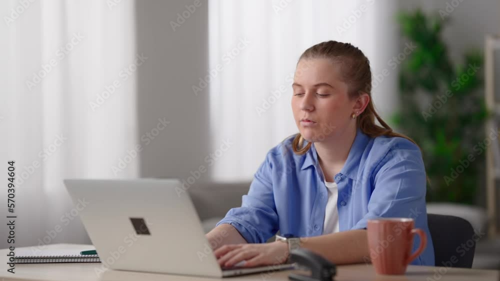 Freelancer working on laptop at home. Pretty woman with stress overworking and resting head on desk Freelancer working on laptop at home. Pretty woman with stress overworking and resting head on desk