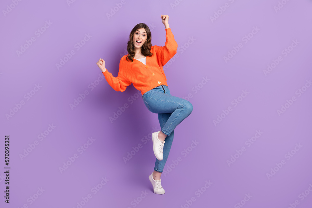 Full body length size photo of young excited optimistic woman fists up wear stylish outfit celebrate victory isolated on purple color background Full body length size photo of young excited optimistic woman fists up wear stylish outfit celebrate victory isolated on purple color background
