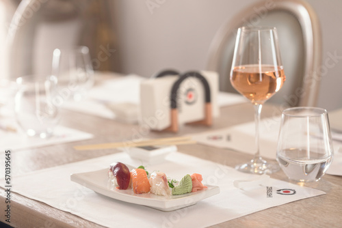 Young couple sharing a plate of sushi rolls, as they enjoy a romantic night out, experiencing the flavors and ambiance of a traditional Japanese restaurant