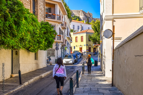 Local Athenians walk through a residential area of the Plaka district under the Acropolis Hill in Athens, Greece.