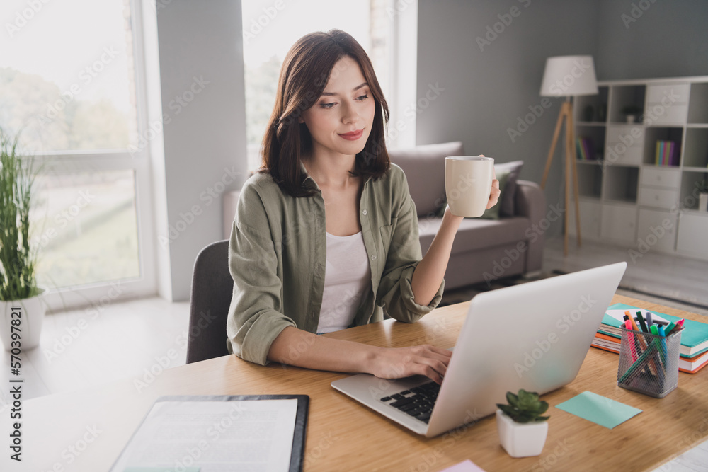 Photo of intelligent lawyer girl sitting chair arm hold fresh hot coffee mug use wireless netbook modern workplace inside Photo of intelligent lawyer girl sitting chair arm hold fresh hot coffee mug use wireless netbook modern workplace inside