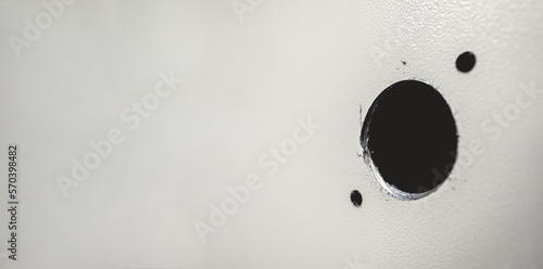 Closeup of detail of a drilled holes in a steel surface (panoramic with big copy space)