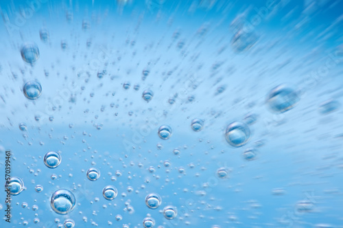 Close-up bubbles under water on blue background.