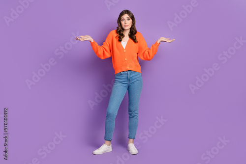 Full body length photo of young funny unsure no idea woman wearing stylish outfit shrug shoulders dont know isolated on purple color background © deagreez