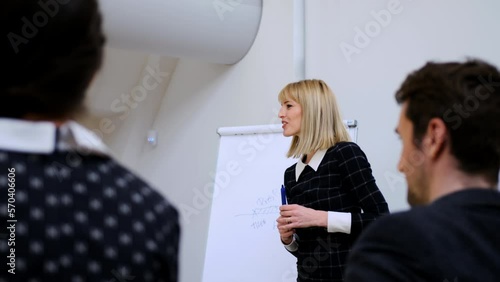 HR expert giving lecture to group of young business people
