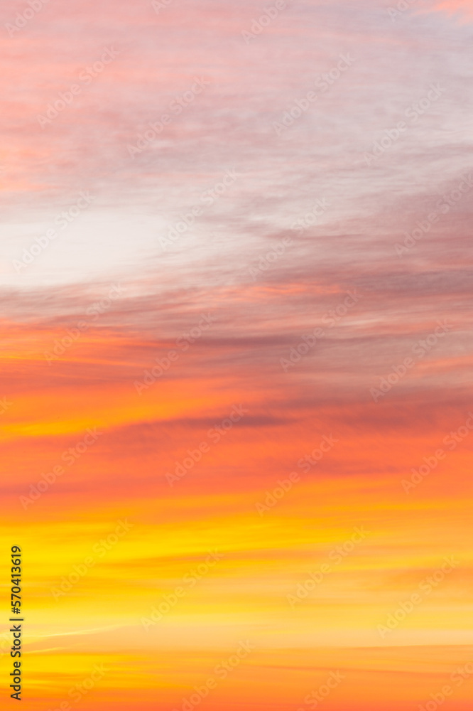 Sky with soft and fluffy pastel orange pink and blue colored clouds. Sunset background. Nature. sunrise. Instagram toned style. Vertical