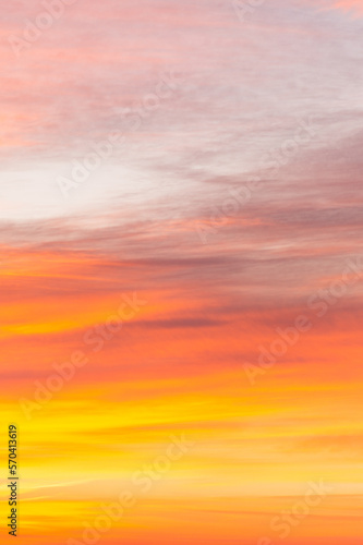 Sky with soft and fluffy pastel orange pink and blue colored clouds. Sunset background. Nature. sunrise. Instagram toned style. Vertical © flowertiare