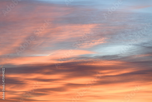 Sky with soft and fluffy pastel orange pink and blue colored clouds. Sunset background. Nature. sunrise. Instagram toned style © flowertiare