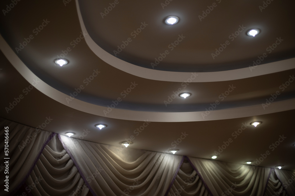 Lamps in ceiling. Multi-level ceiling. Interior design.