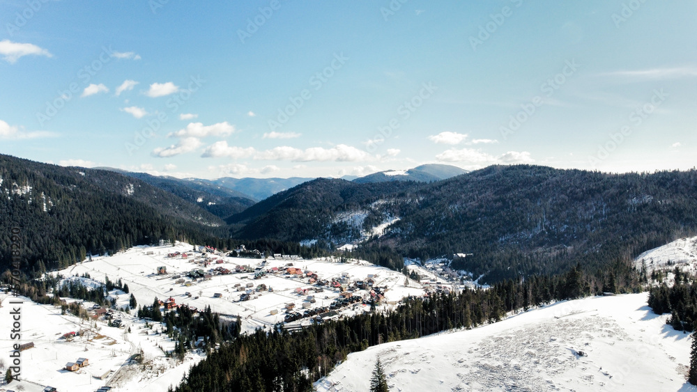 Carpathian mountains. Beautiful winter landscape on a sunny day. Winter landscape with snow-covered mountain under sunlight. Winter fairy tale. Stunning nature background.