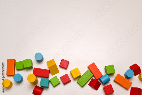 wooden colorful figures bright multicolored bricks on a white table. the concept of children's development. mock up