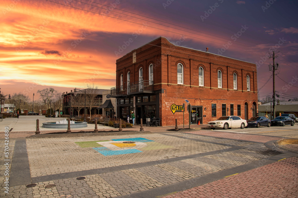 Gritz Brunch Bar in O'neal Plaza with metal benches, bare winter trees, lush green plants, tall