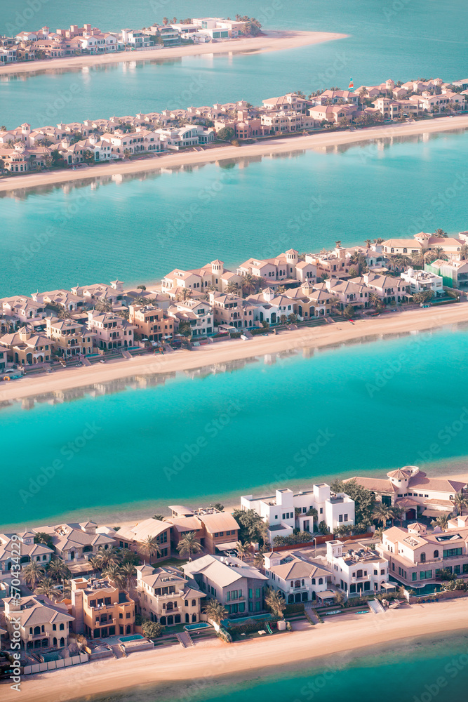 Dubai, UAE. The Palm Jumeirah. Holidays villas, beaches and luxury hotels view at sunset.