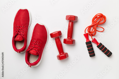 Red sport equipment on color background, top view © Liami