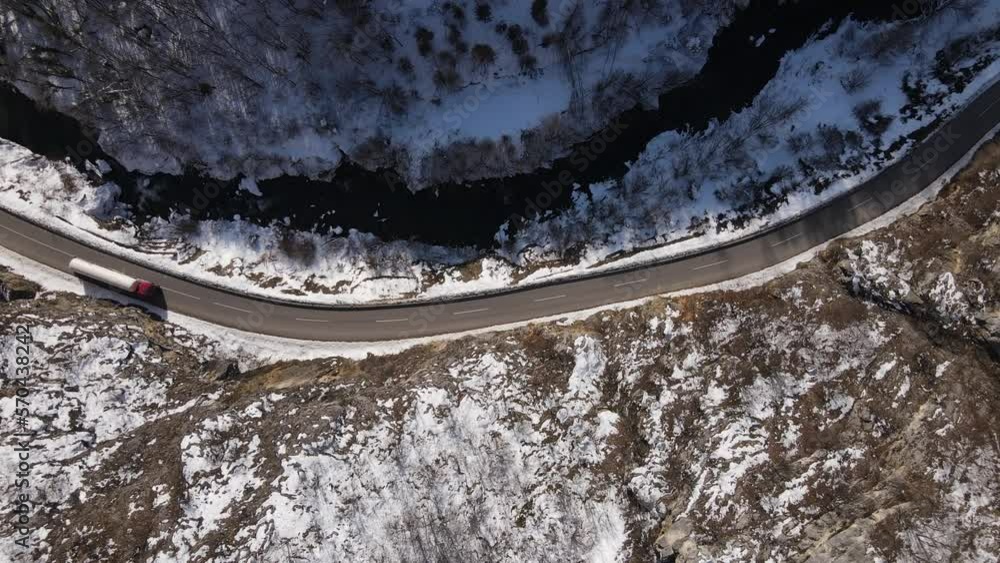 truck drive in snow winter day on the road in mountain aerial view truck drive in snow winter day on the road in mountain aerial view