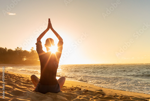 Female practicing meditation on the beach. Mind health body spirit concept. 
