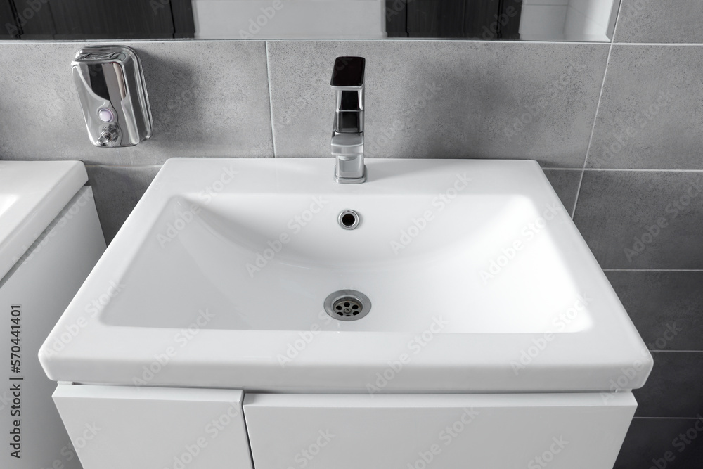 Beautiful clean sink near mirror in public toilet Beautiful clean sink near mirror in public toilet