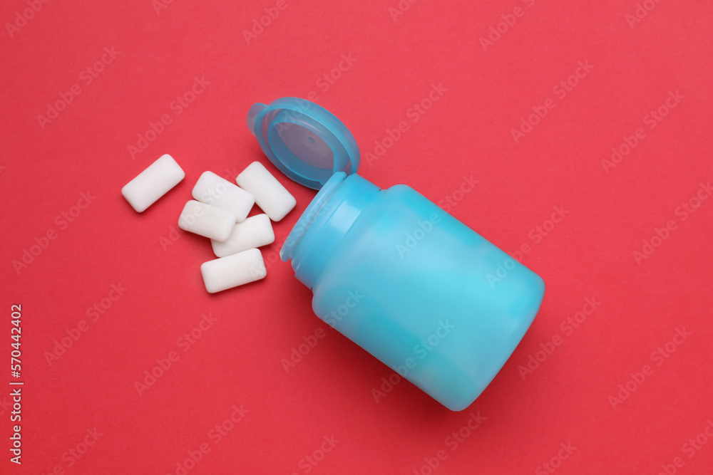 Jar with chewing gums on red background, flat lay Jar with chewing gums on red background, flat lay