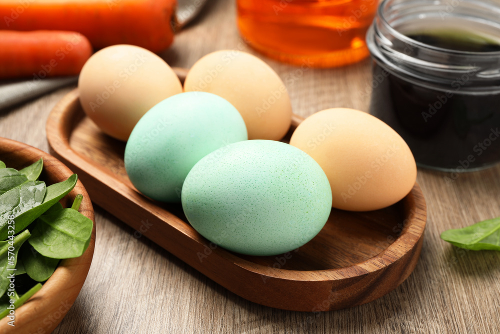 Naturally painted Easter eggs on wooden table, closeup. Spinach used for coloring Naturally painted Easter eggs on wooden table, closeup. Spinach used for coloring