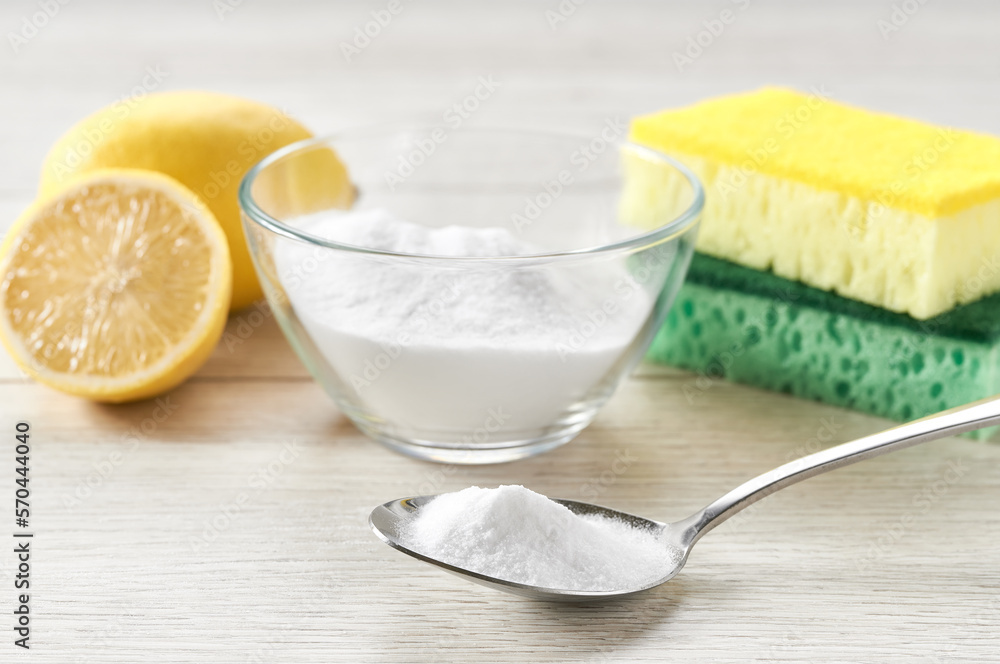 non-toxic cleaner, baking soda and lemon on a white kitchen table. non-toxic cleaner, baking soda and lemon on a white kitchen table.