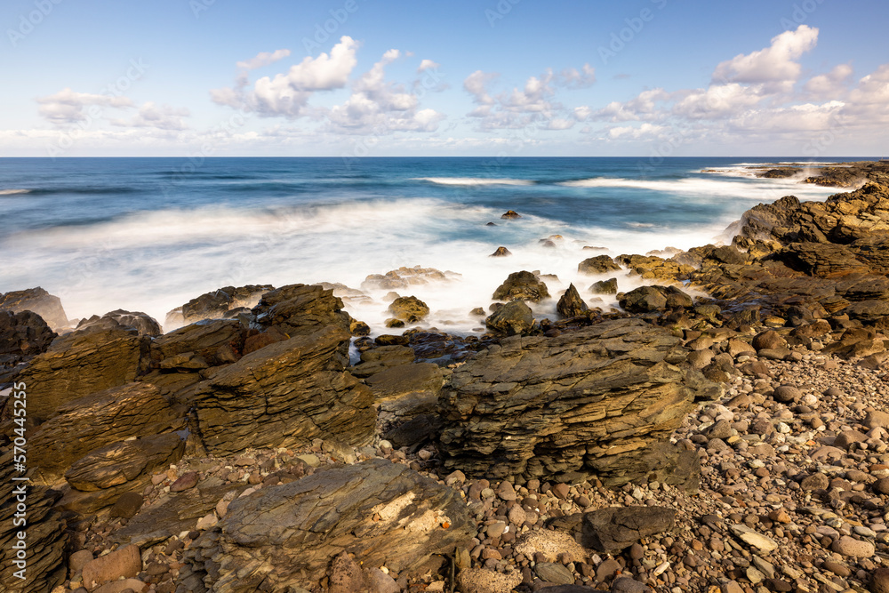 Nature's Fury: The Ocean's Power on Display at Daylight with Clouds Above