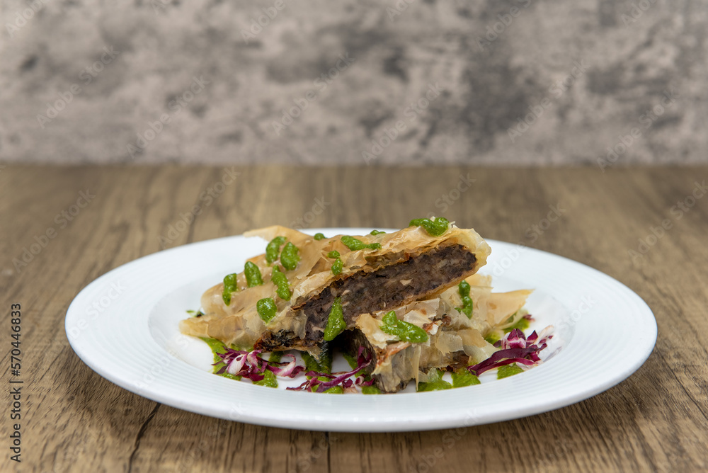 Tempting appetizer of mushroom strudel in filo dough served on a small plate Tempting appetizer of mushroom strudel in filo dough served on a small plate