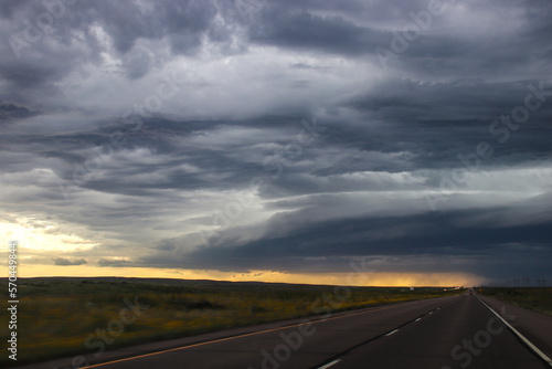 Rural highway passes dramatic skies, over the prairie - Eastern Colorado © Simon Foot