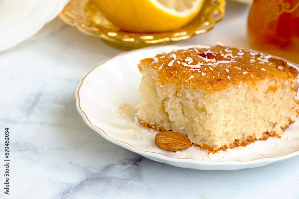 Basbousa or namoora traditional arabic semolina cake with cashew nuts and syrup. Selective focus. Basbousa or namoora traditional arabic semolina cake with cashew nuts and syrup. Selective focus.