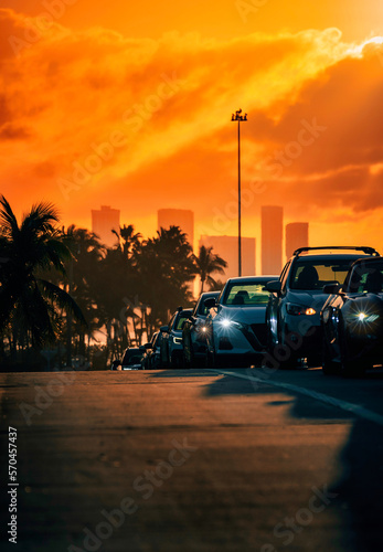 sunset on the street road miami usa florida horizon skyscrapers lights cars traffic 