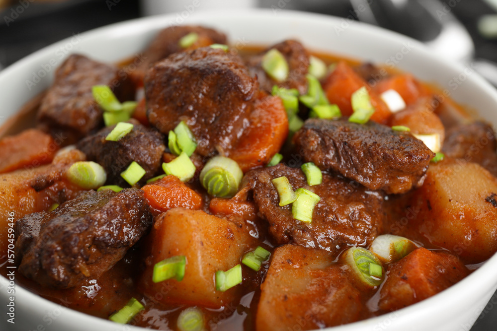 Delicious beef stew with carrots, green onions and potatoes, closeup Delicious beef stew with carrots, green onions and potatoes, closeup