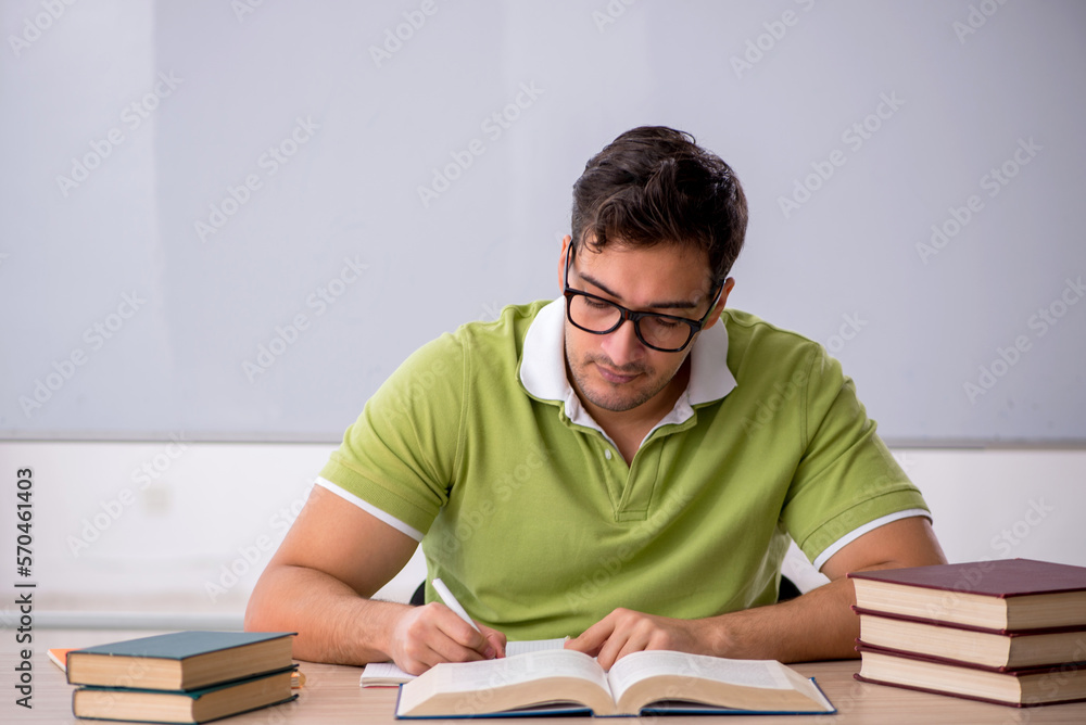 Young male student preparing for exams in the classroom Young male student preparing for exams in the classroom