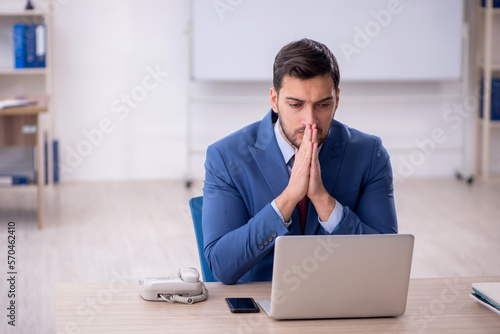 Young male employee working in the office