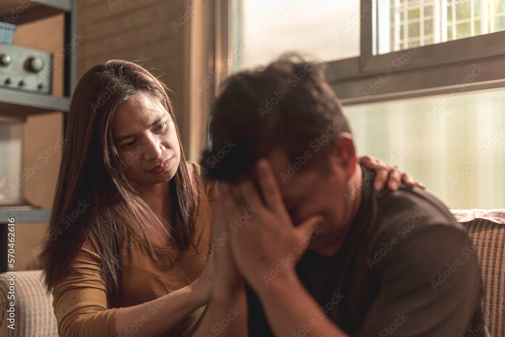 A concerned wife comforts her husband who breaks down and cries. Being there for a partner during hard times. A concerned wife comforts her husband who breaks down and cries. Being there for a partner during hard times.