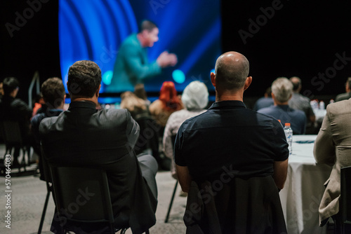Men watching the screen at a leadership conference