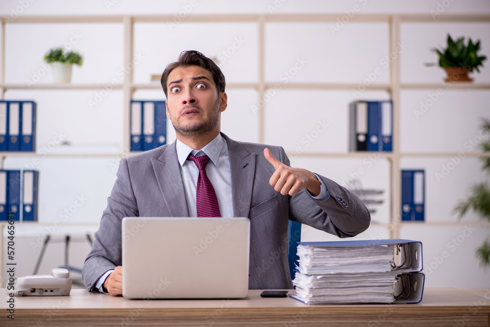 Young male employee working in the office Young male employee working in the office