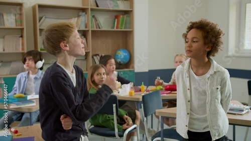Elementary school class children communicate with the teacher answering question