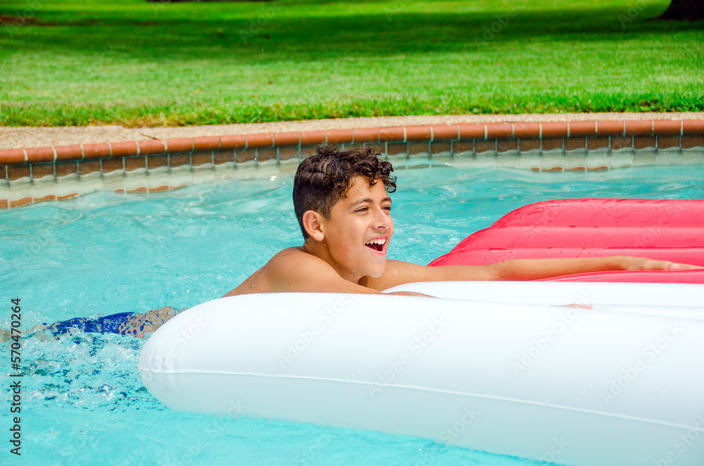 Young Youth Male Boy Teen Playing with Raft in Swimming Pool