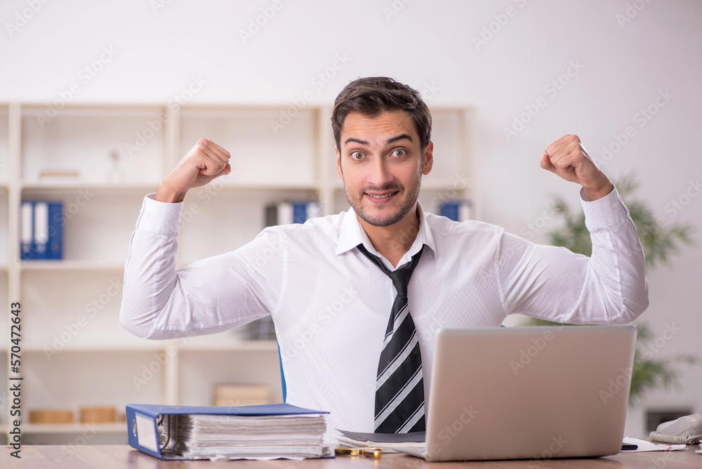 Young male employee working in the office Young male employee working in the office