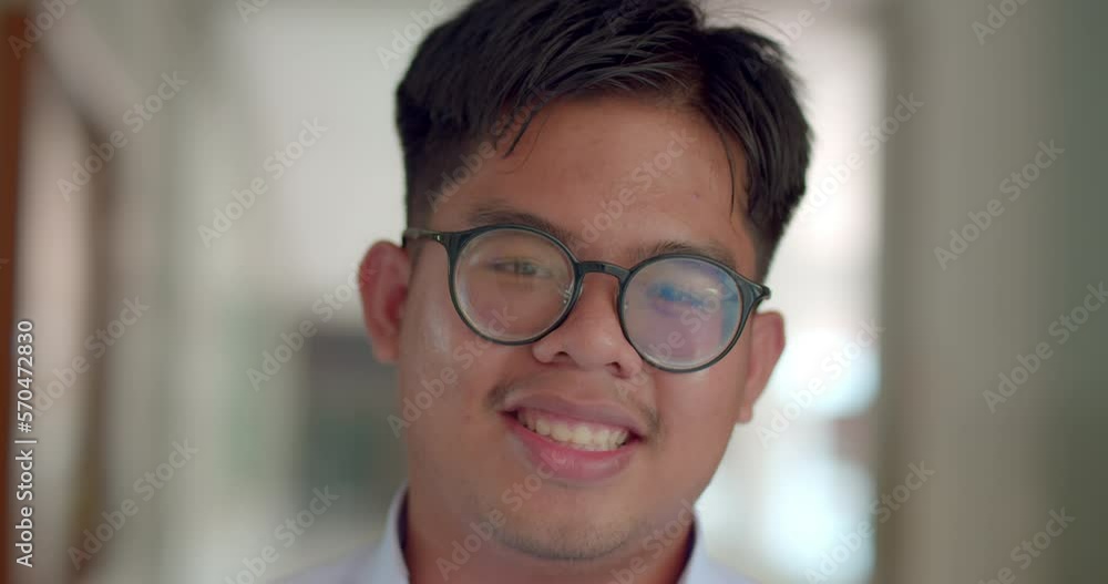 A little smile of an Asian male teenage high school student wearing ...