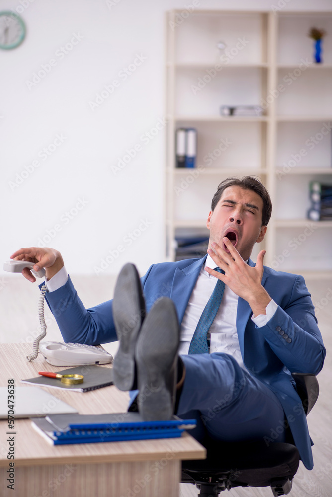 Young male employee working in the office Young male employee working in the office