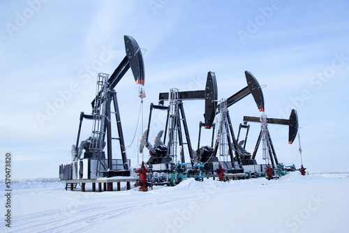 Принти на полотні Winter in the oilfield cowered with white snow with black pumpjacks