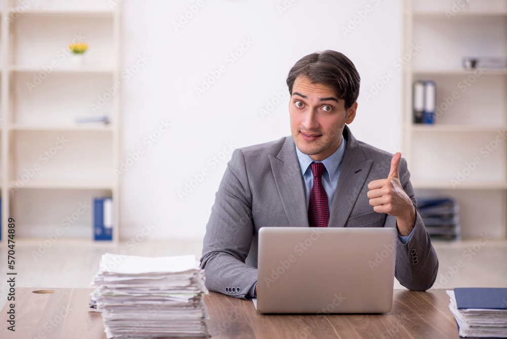 Young male employee working in the office Young male employee working in the office
