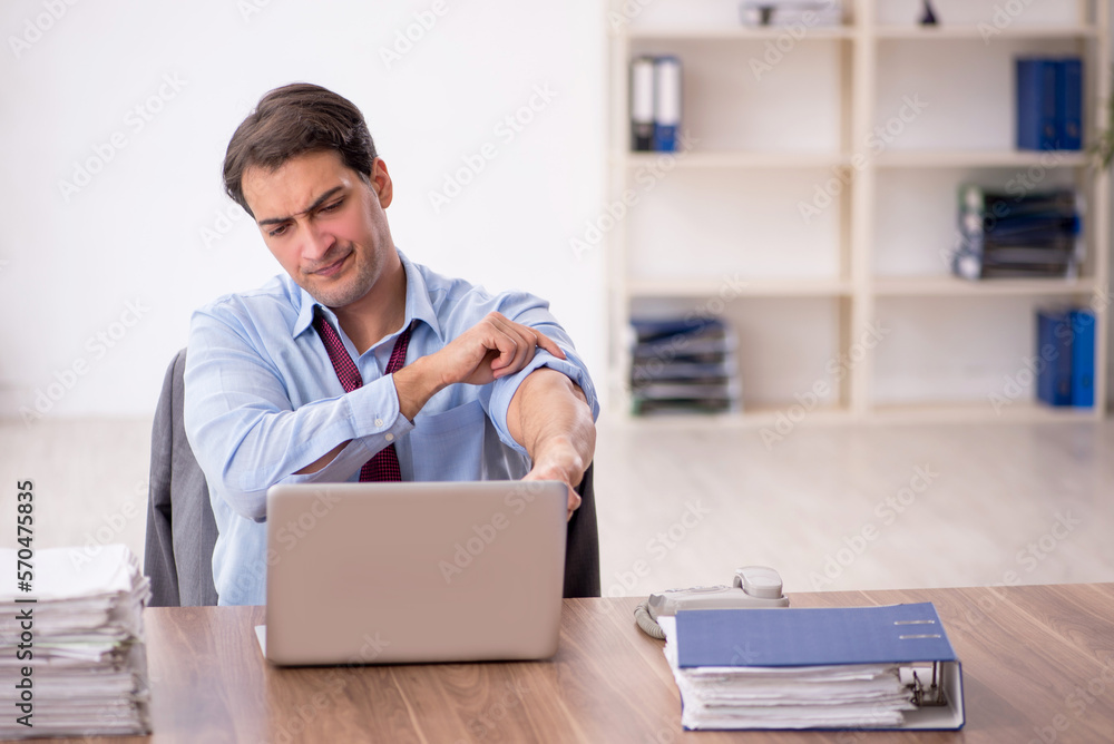 Young male employee working in the office Young male employee working in the office