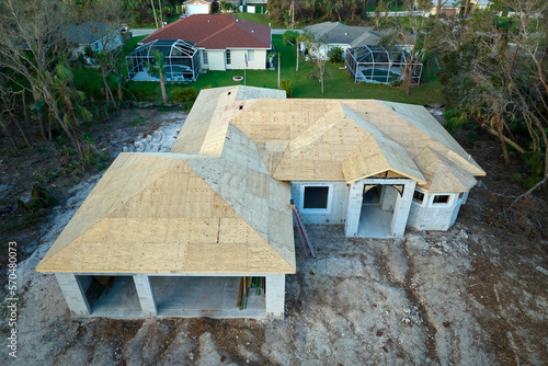Bilde på lerret Aerial view of residential private home with wooden roofing structure under construction in Florida quiet rural area