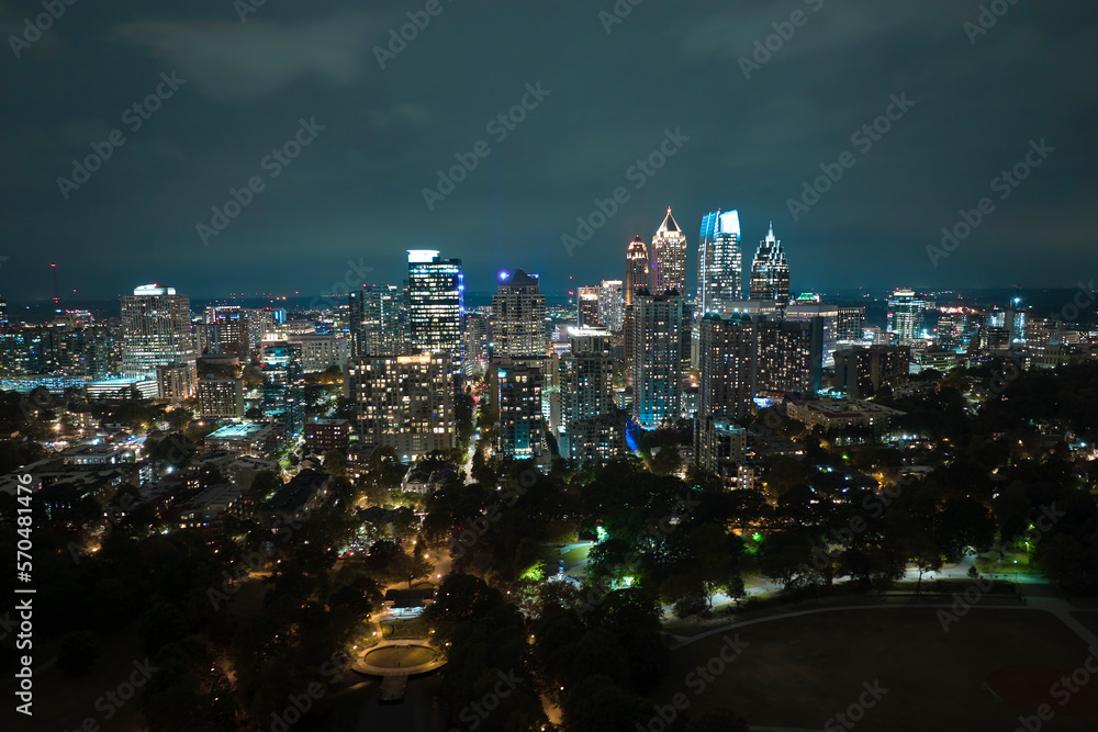 Obraz premium Night urban landscape of downtown district of Atlanta city in Georgia, USA. Skyline with brightly illuminated high skyscraper buildings in modern american megapolis
