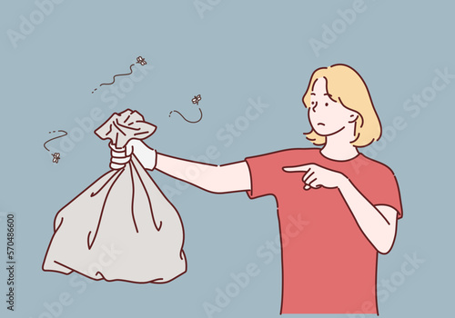 Young woman holding a garbage bag and pointing isolated on gray background. Hand drawn style vector design illustrations.