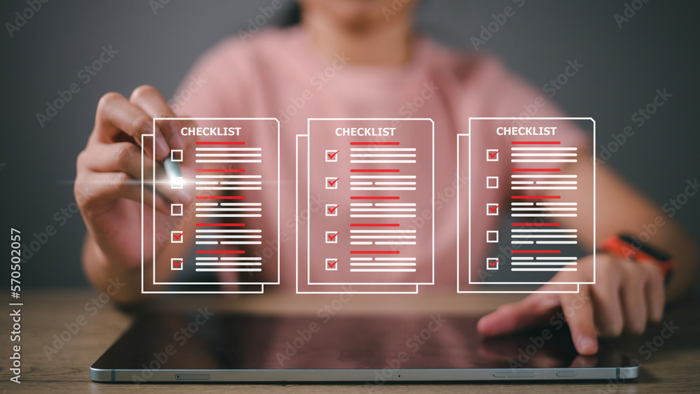 Checklist concept, Woman checking marks on the check boxes with marker red Stock Photo Adobe Stock